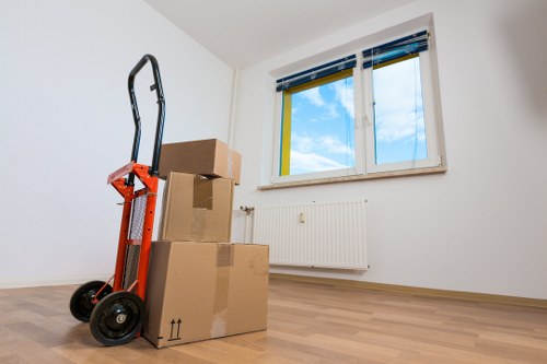 Packed office boxes and labelled furniture for relocation